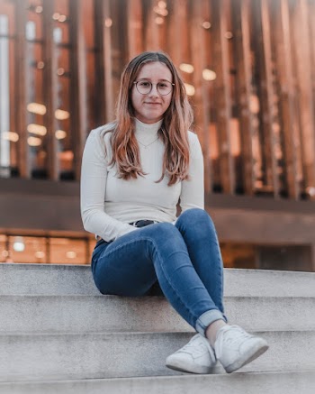 Woman Sits on Stairwell Outside the Building