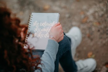 Woman Sitting and Holding Book