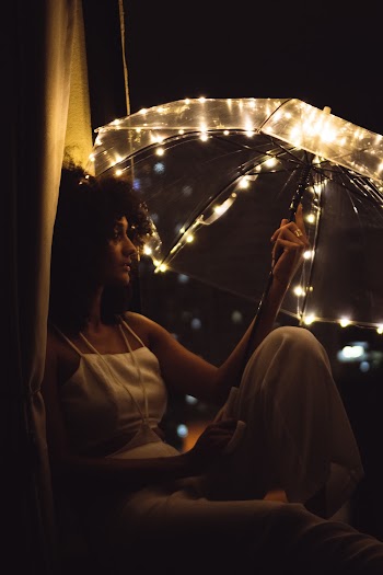 Woman Sitting and Holding Umbrella