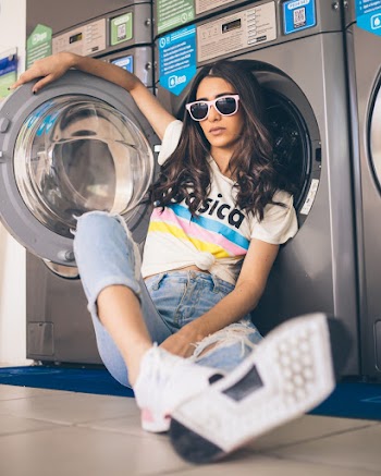 Woman Sitting and Leaning on Washer