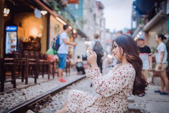 Woman Sitting and Using Dslr Camera
