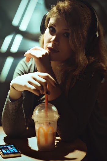 Woman Sitting and Wearing Headphons