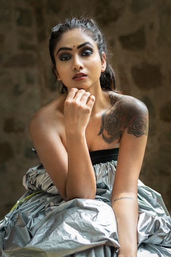 Woman Sitting and Wearing Silver Strapless Top