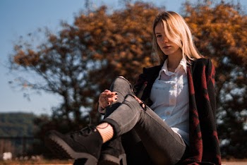 Woman Sitting Behind Tree