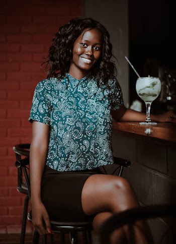 Woman Sitting Beside Bar Counter
