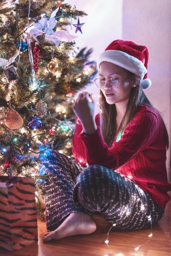 Woman Sitting Beside Christmas Tree