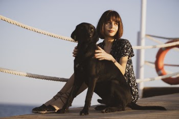 Woman Sitting Beside Dog