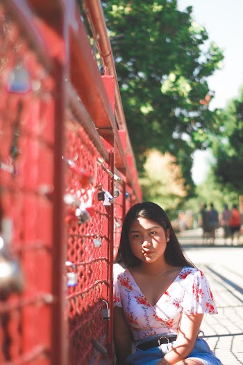Woman Sitting Beside Fence