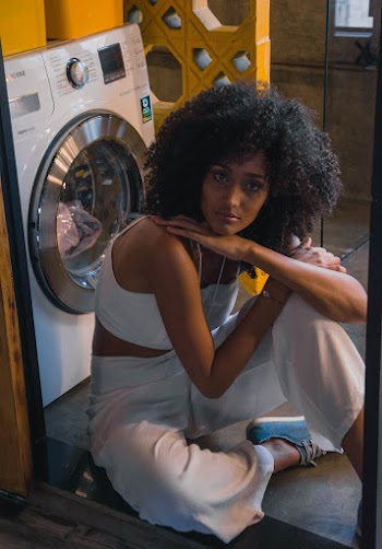 Woman Sitting Beside Front-load Clothes Dryer