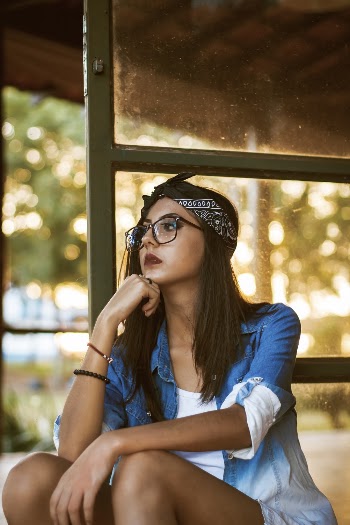 Woman Sitting Beside Glass Door