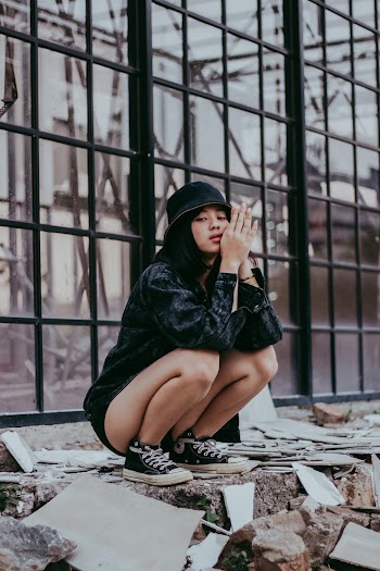 Woman Sitting Beside Glass Wall