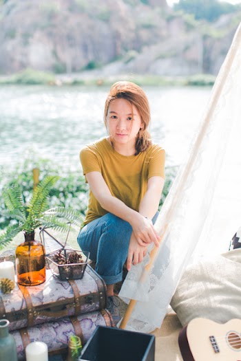 Woman Sitting Beside Green Leaf Potted Plant