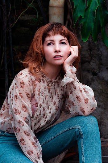 Woman Sitting Beside Plant
