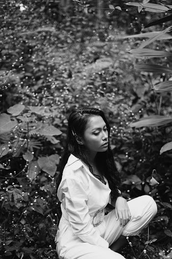 Woman Sitting Beside Plant