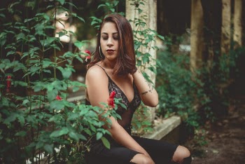 Woman Sitting Beside Plants