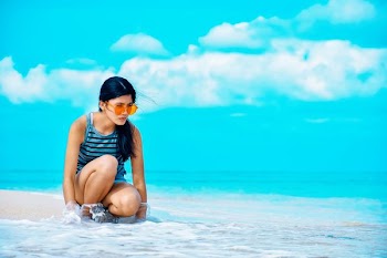 woman sitting beside seashore
