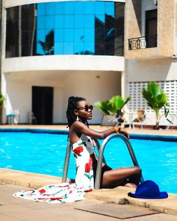 Woman Sitting Beside Swimming Pool