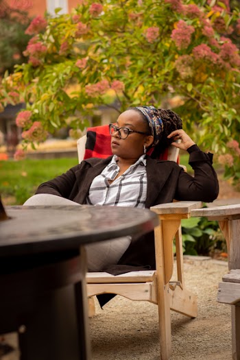 Woman Sitting Beside Table