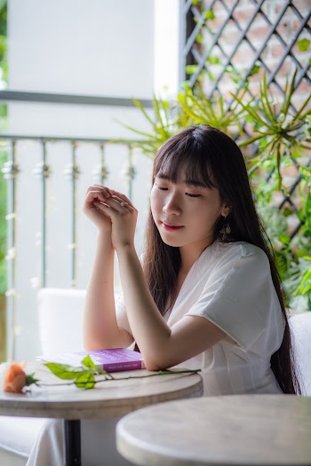 Woman Sitting Beside Table