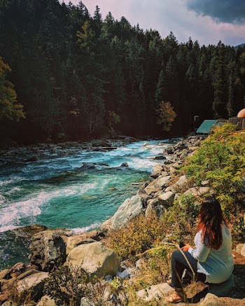 Woman Sitting Beside the River