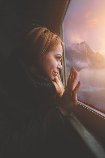 Woman Sitting Beside Vehicle Window