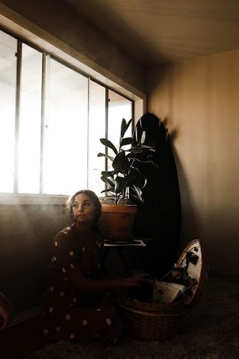 woman sitting beside window
