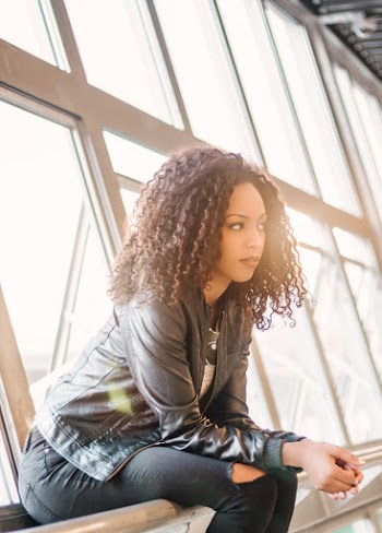 Woman Sitting Beside Window