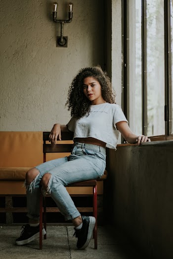 Woman Sitting Beside Window