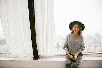 Woman Sitting Beside Window Glass