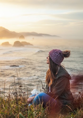 Woman Sitting By The Cliff