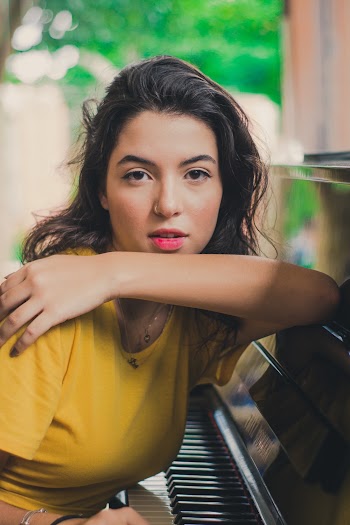 Woman Sitting By The Piano