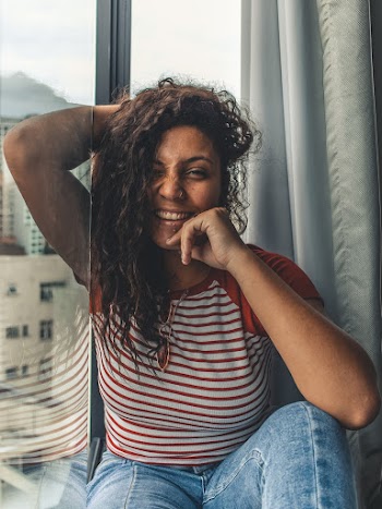 Woman Sitting By The Window