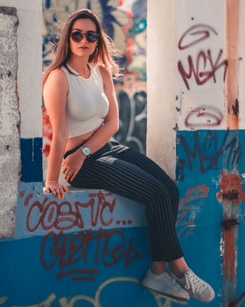 Woman Sitting Down Between Concrete Stand