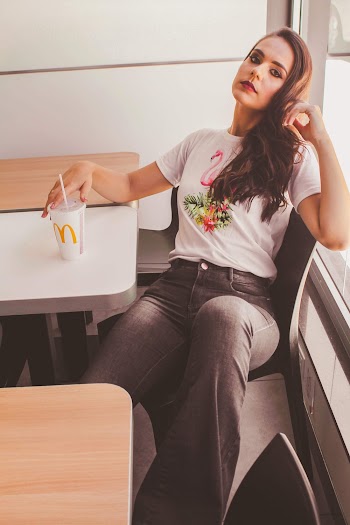 Woman Sitting Down Holding Mcdonald's Cup
