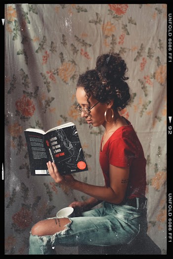 Woman Sitting Down While Reading Book