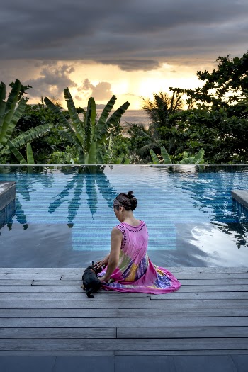 Woman Sitting Facing Pool