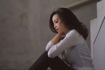 Woman Sitting Holding Her Hair