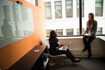 Woman Sitting in Chair Near Board