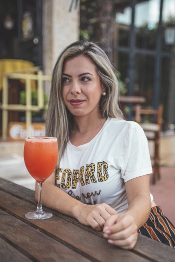Woman Sitting in Front Beverage Glass