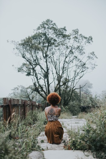Woman Sitting in Front of a Tree