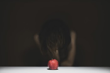 Woman Sitting in Front of Apple