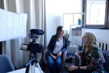 Woman Sitting in Front of Camera