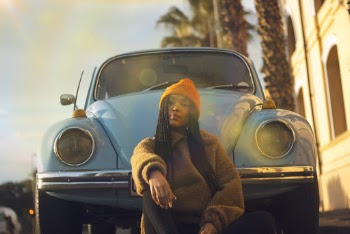 Woman Sitting in Front of Car