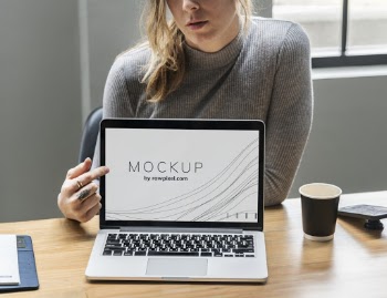 Woman Sitting in Front of Macbook Pro