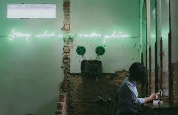 Woman Sitting in Front of Mirror While Using Smartphone