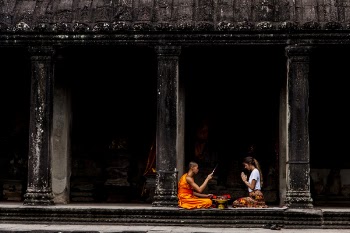 Woman Sitting in Front of Monk