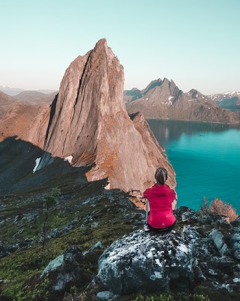 Woman Sitting in Front of Mountain