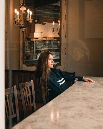Woman Sitting in Front of Table