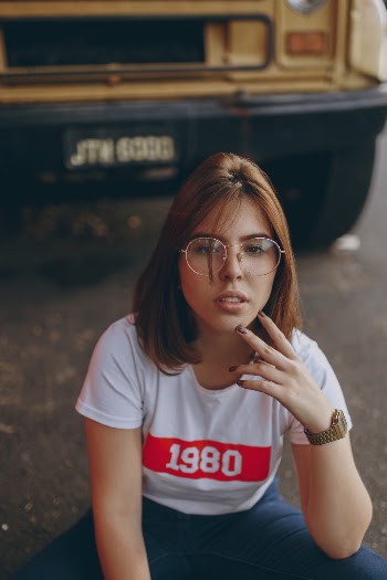 Woman Sitting in Front of Yellow Truck