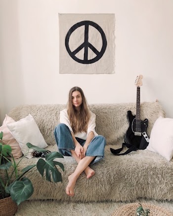 Woman Sitting in Grey Fur Sofa 